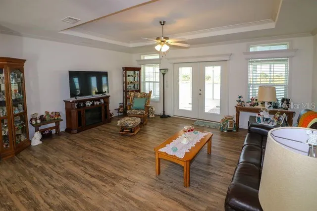 a living room with furniture a flat screen tv and wooden floor