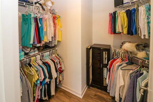 a view of walk in closet with clothes