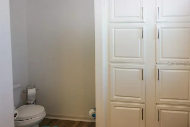 a white toilet sitting next to a shower
