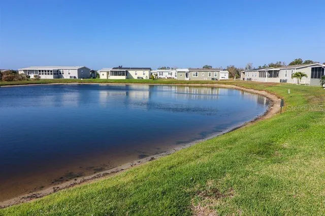 a view of a swimming pool with an outdoor seating and a yard