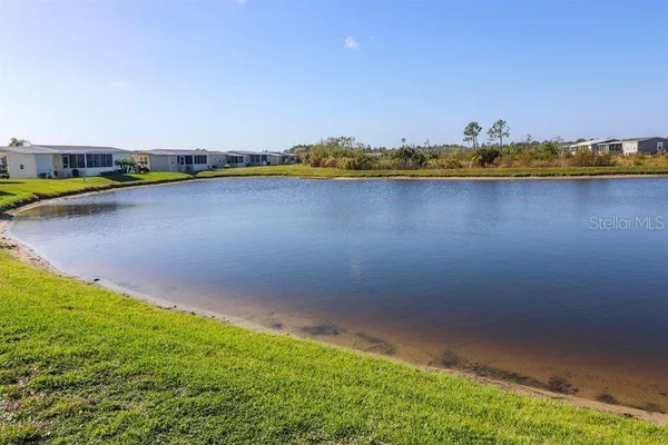 a view of a lake with houses in the back
