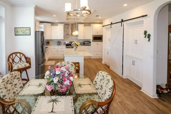 a kitchen with stainless steel appliances kitchen island granite countertop a refrigerator and microwave