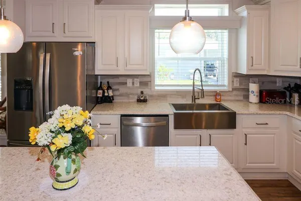 a kitchen with a refrigerator and a sink