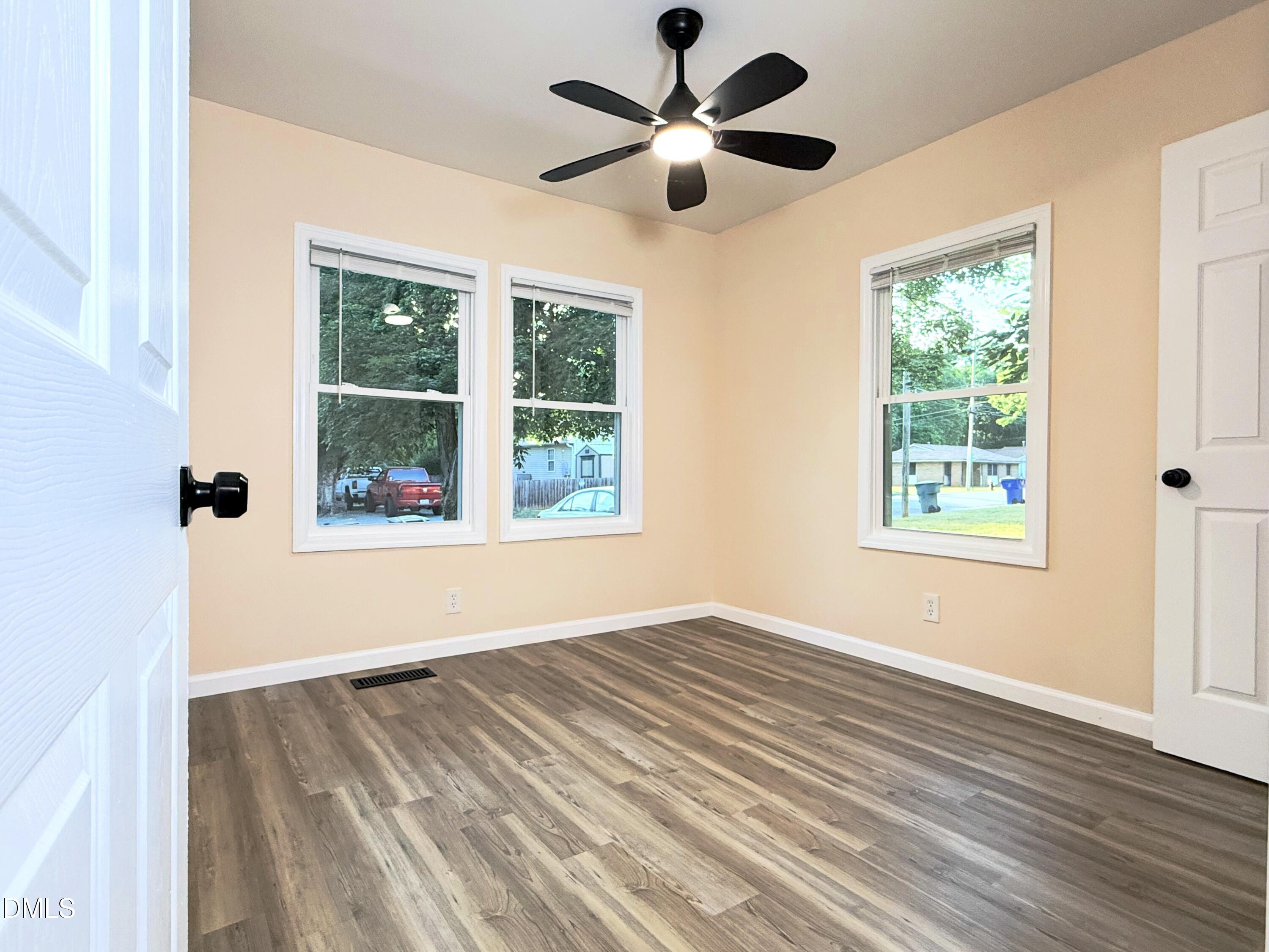 417 North Street Graham, NC 27253 - Photo 17 of 18 a view of an empty room with a window and wooden floor