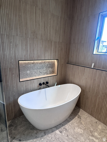 1918 Chimney Rock Road Heber City, UT 84032 - Photo 59 of 74 Freestanding soaking tub set against textured vertical wall tiles