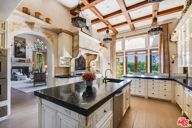 a living room with fireplace furniture and a large window