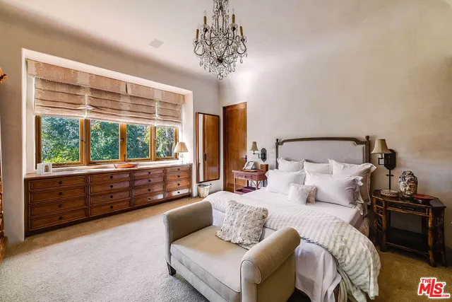 a spacious bathroom with a mirror and bathtub