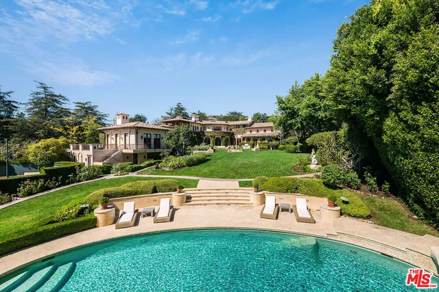 a swimming pool with an outdoor space and seating area