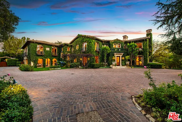 a living room with furniture chandelier and a large window