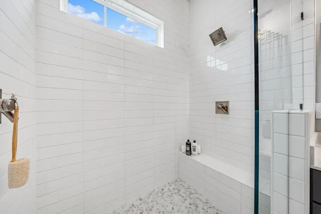 a bathroom with a double vanity sink mirror and shower