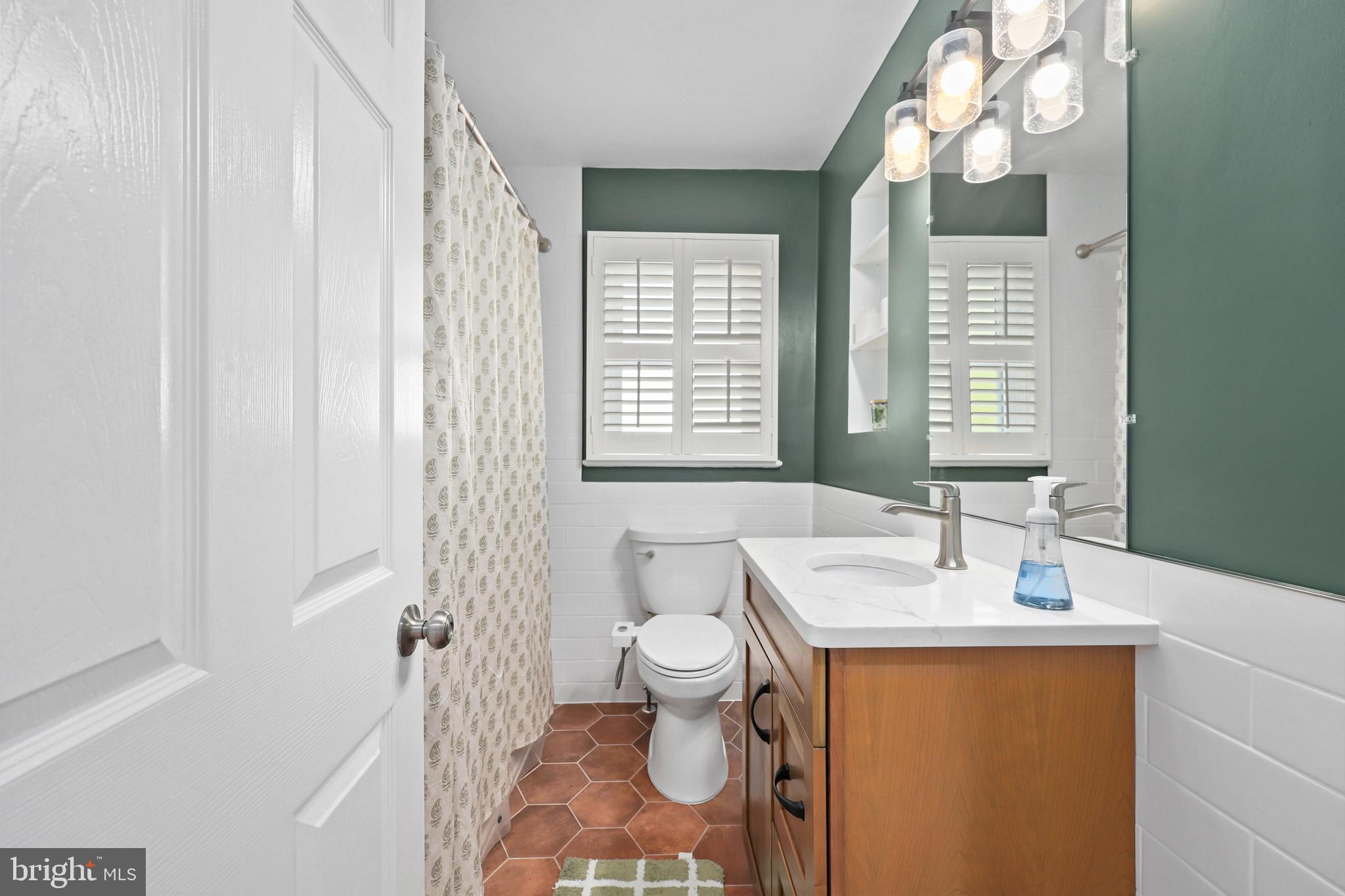 9106 Battle Street Manassas, VA 20110 - Photo 16 of 50 a bathroom with a sink a toilet and a mirror
