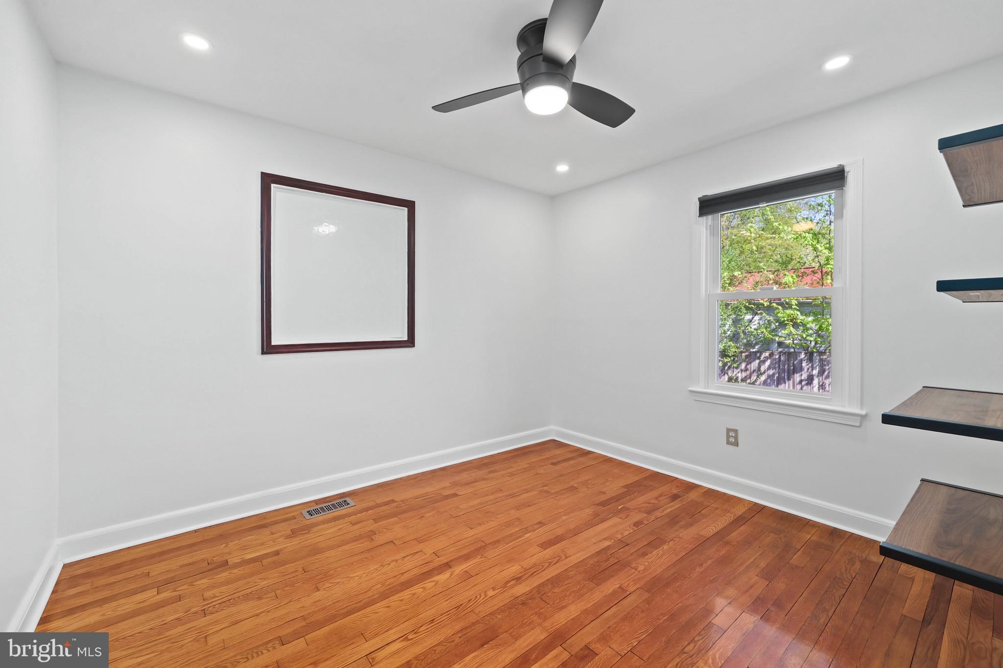 9106 Battle Street Manassas, VA 20110 - Photo 17 of 50 a view of empty room with wooden floor and fan