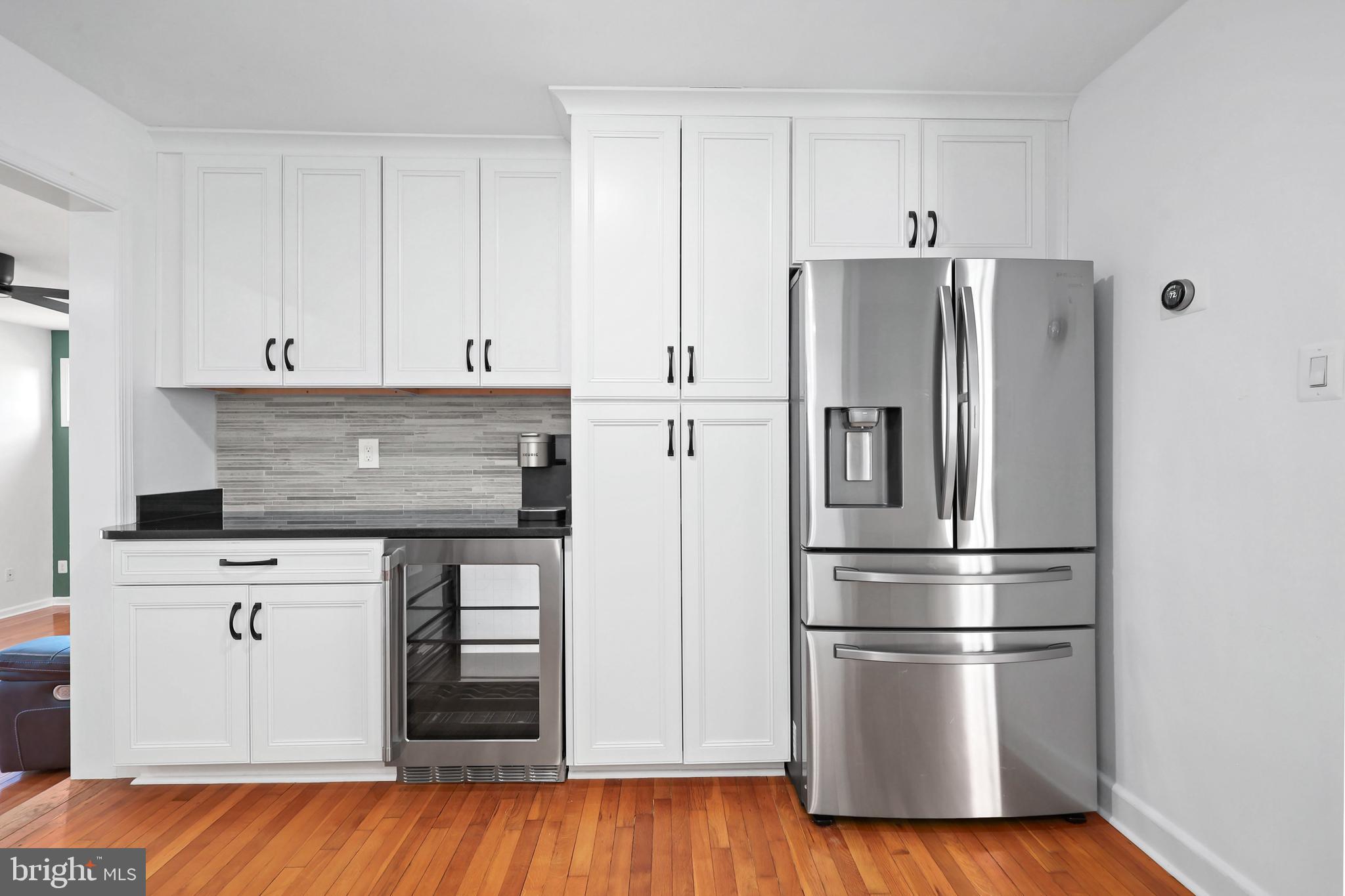 9106 Battle Street Manassas, VA 20110 - Photo 21 of 50 a kitchen with stainless steel appliances wooden floor and white cabinet