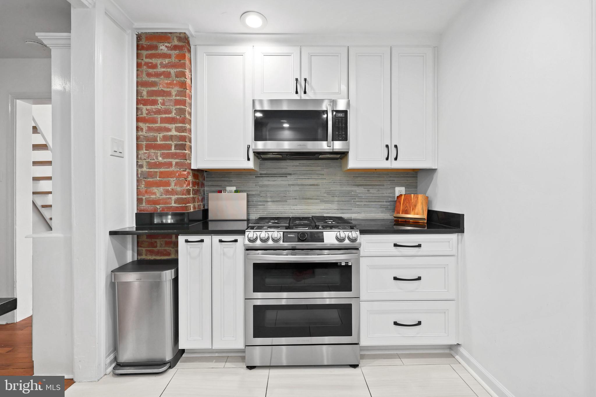 9106 Battle Street Manassas, VA 20110 - Photo 23 of 50 a kitchen with stainless steel appliances granite countertop a stove and a refrigerator