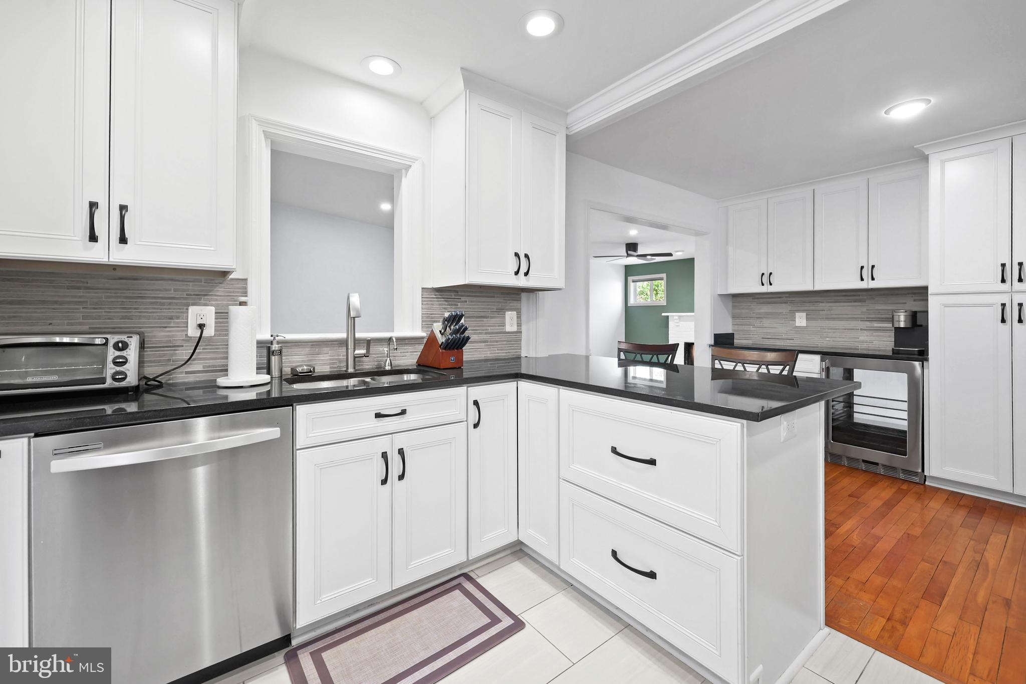 9106 Battle Street Manassas, VA 20110 - Photo 24 of 50 a kitchen with granite countertop white cabinets and white appliances