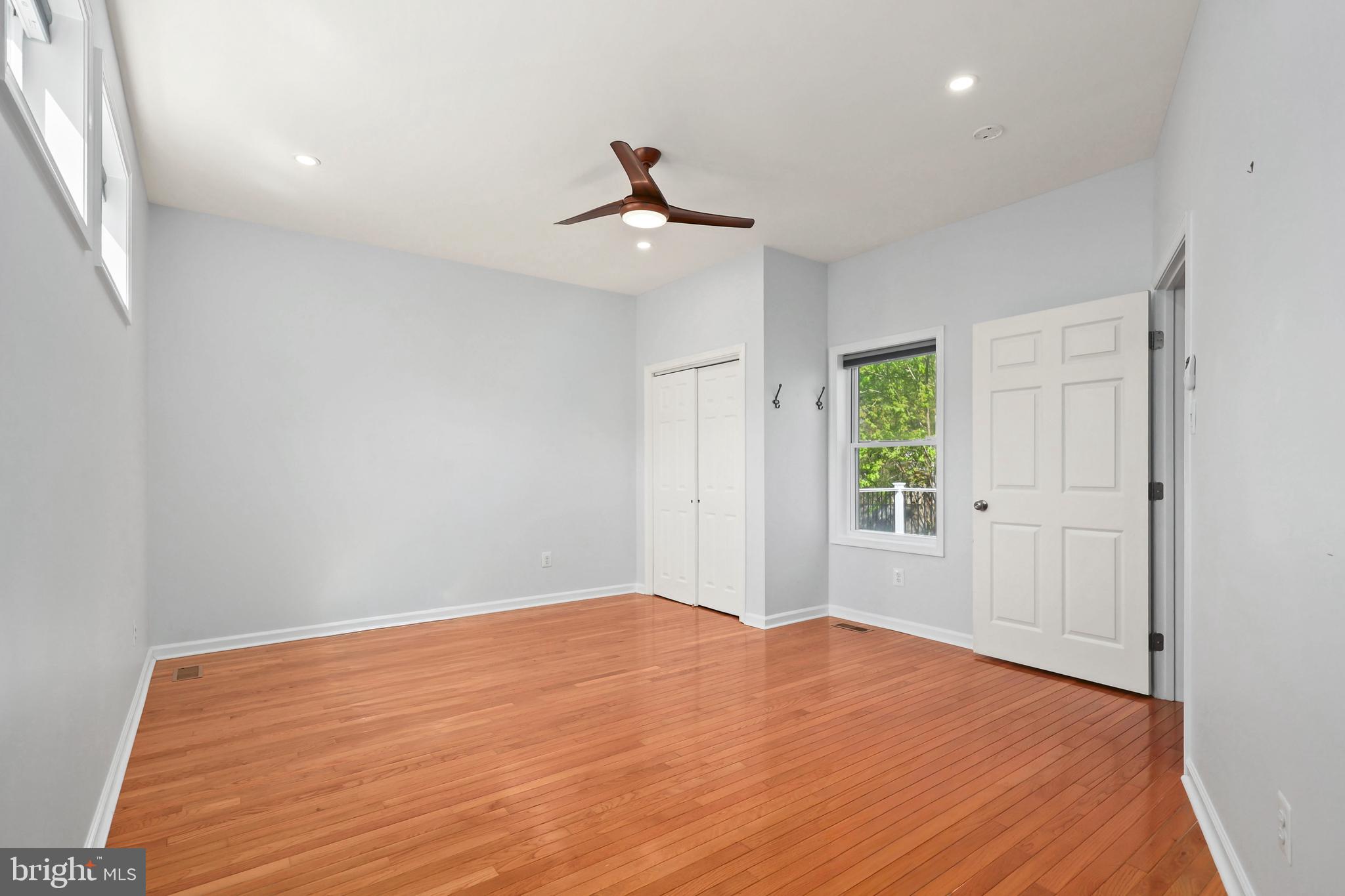 9106 Battle Street Manassas, VA 20110 - Photo 36 of 50 a view of empty room with wooden floor and fan