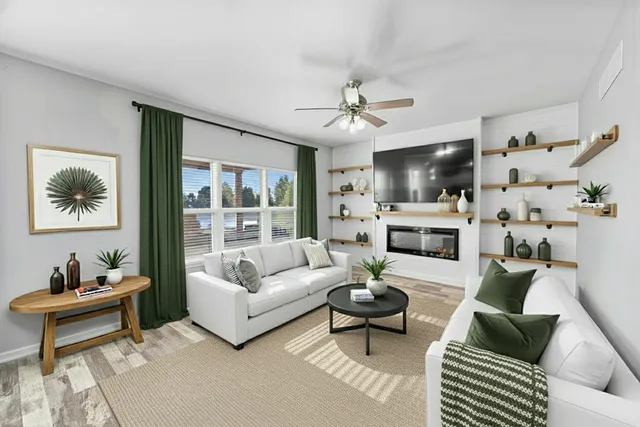 a living room with furniture a rug and a chandelier