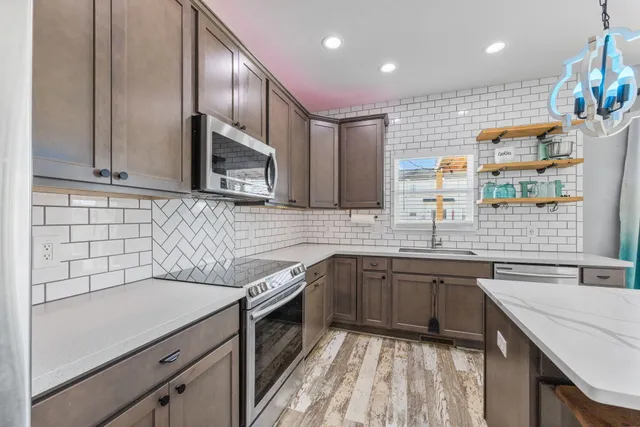 a kitchen with a sink stainless steel appliances and cabinets