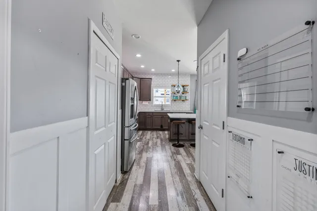 a kitchen with cabinets and wooden floor