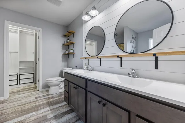 a bathroom with a double vanity sink and a mirror