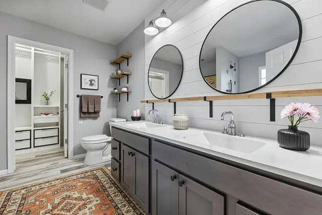 a spacious bathroom with a double vanity sink and a mirror
