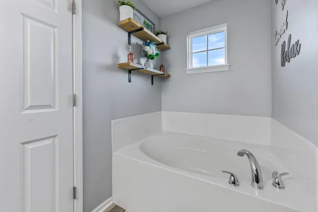 a white bath tub sitting next to a window