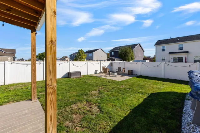 a swimming pool with outdoor seating and yard