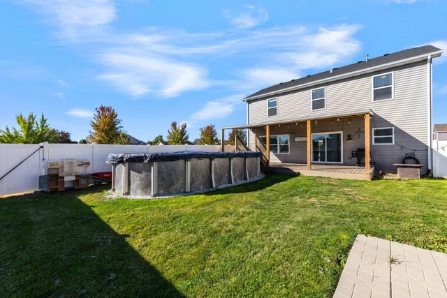 a view of a house with a backyard porch and sitting area