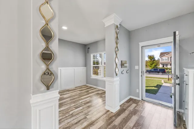 a view of entryway and hall with wooden floor