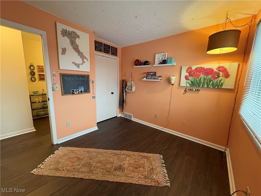 4015 Marks Road, Unit 3C Medina, OH 44256 - Photo 18 of 36 Empty room with a textured ceiling and dark hardwood / wood-style floors