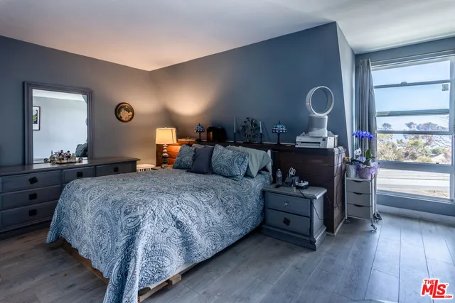 a bedroom with bed and a dresser