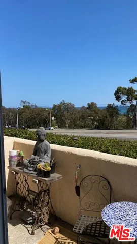 a view of a lake with couches chairs and city view