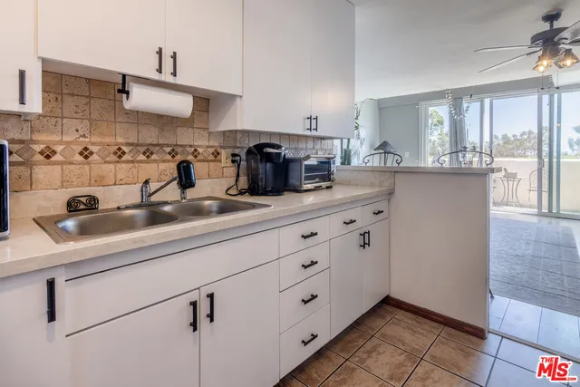 a kitchen with stainless steel appliances granite countertop a sink a stove and cabinets