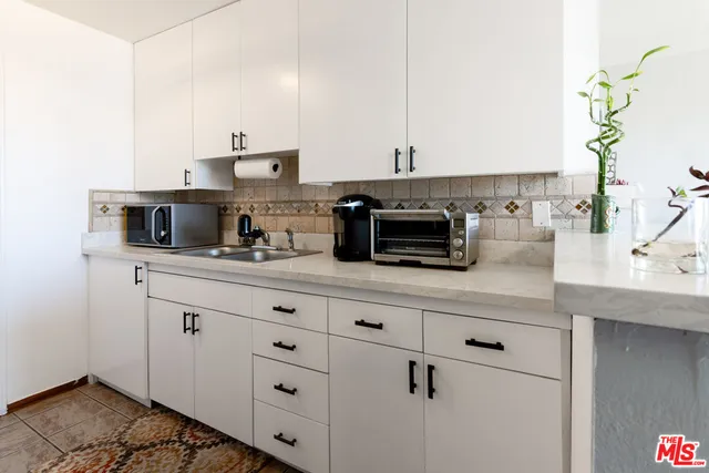 a kitchen with stainless steel appliances a sink and cabinets