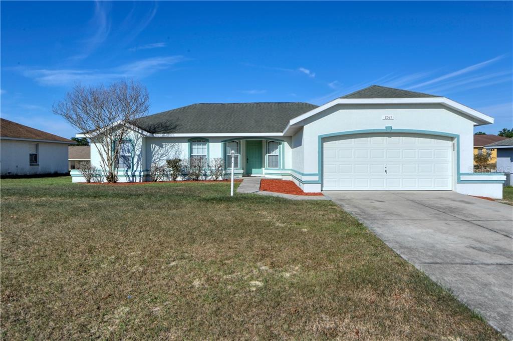 8511 Southwest 133rd Ln Road Ocala, FL 34473 - Photo 1 of 1 a front view of a house with a yard