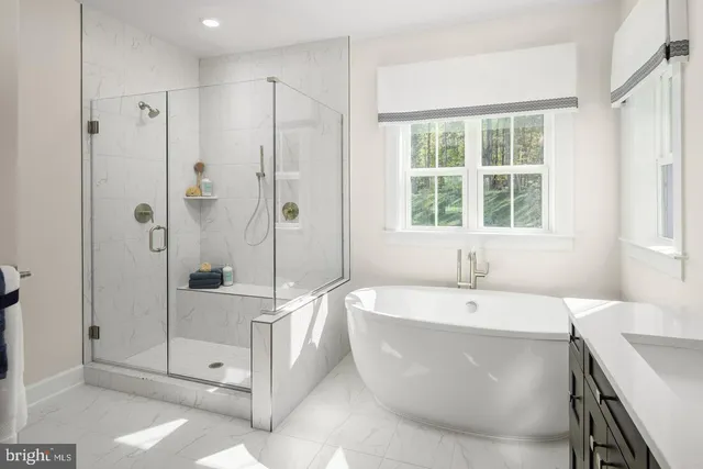 a spacious bathroom with a tub shower and sink