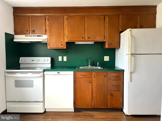 a kitchen with stainless steel appliances a refrigerator sink and cabinets