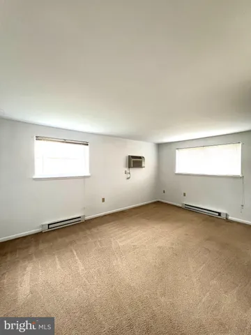 an empty room with a empty space and windows