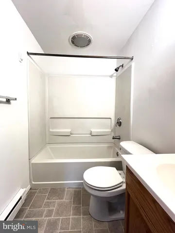 a bathroom with a toilet a sink and a shower