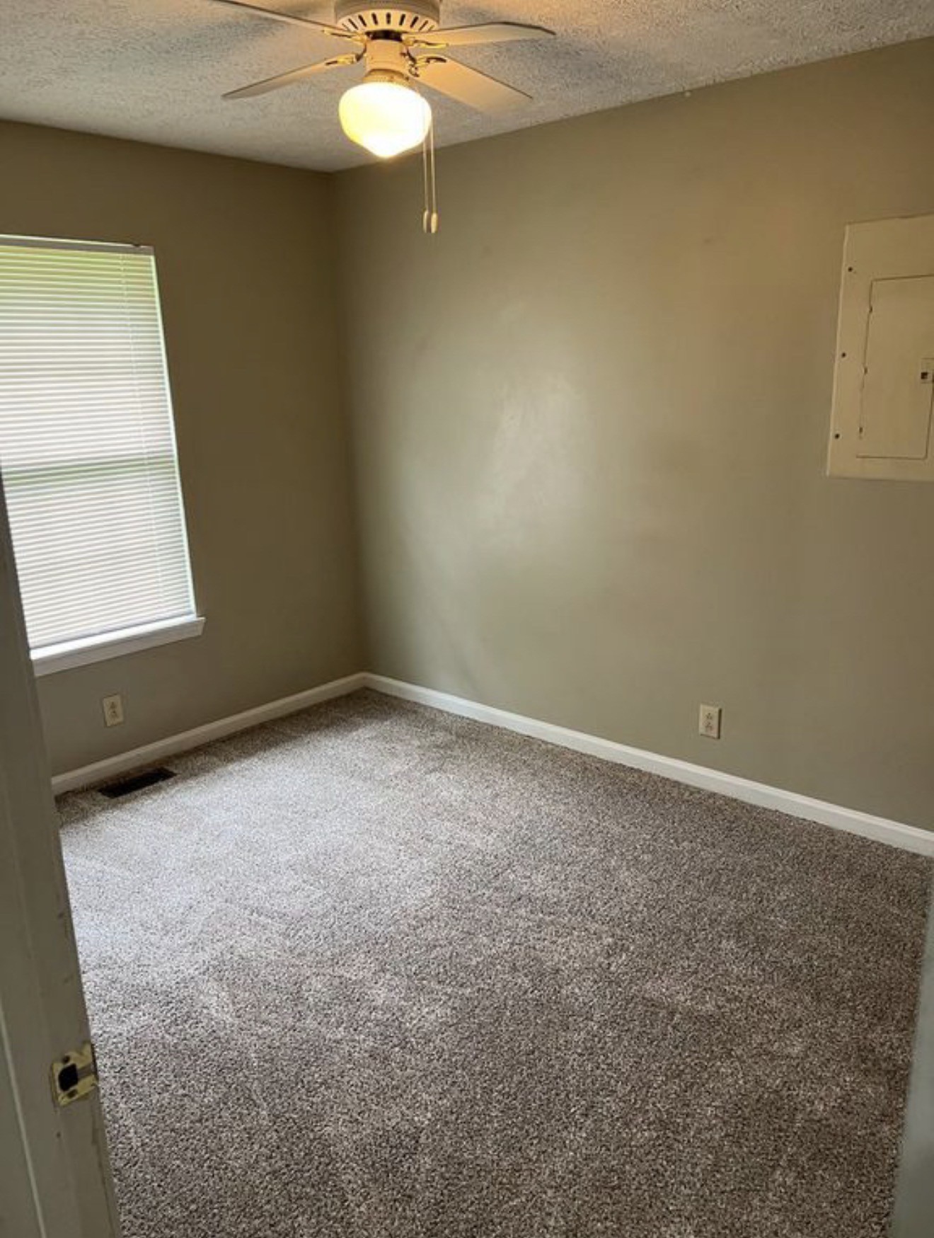 440 Pembroke Oak Grove Road Oak Grove, KY 42262 - Photo 7 of 9 an empty room with a chandelier fan and windows
