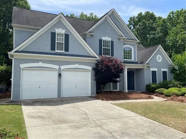 a front view of a house with a yard and garage