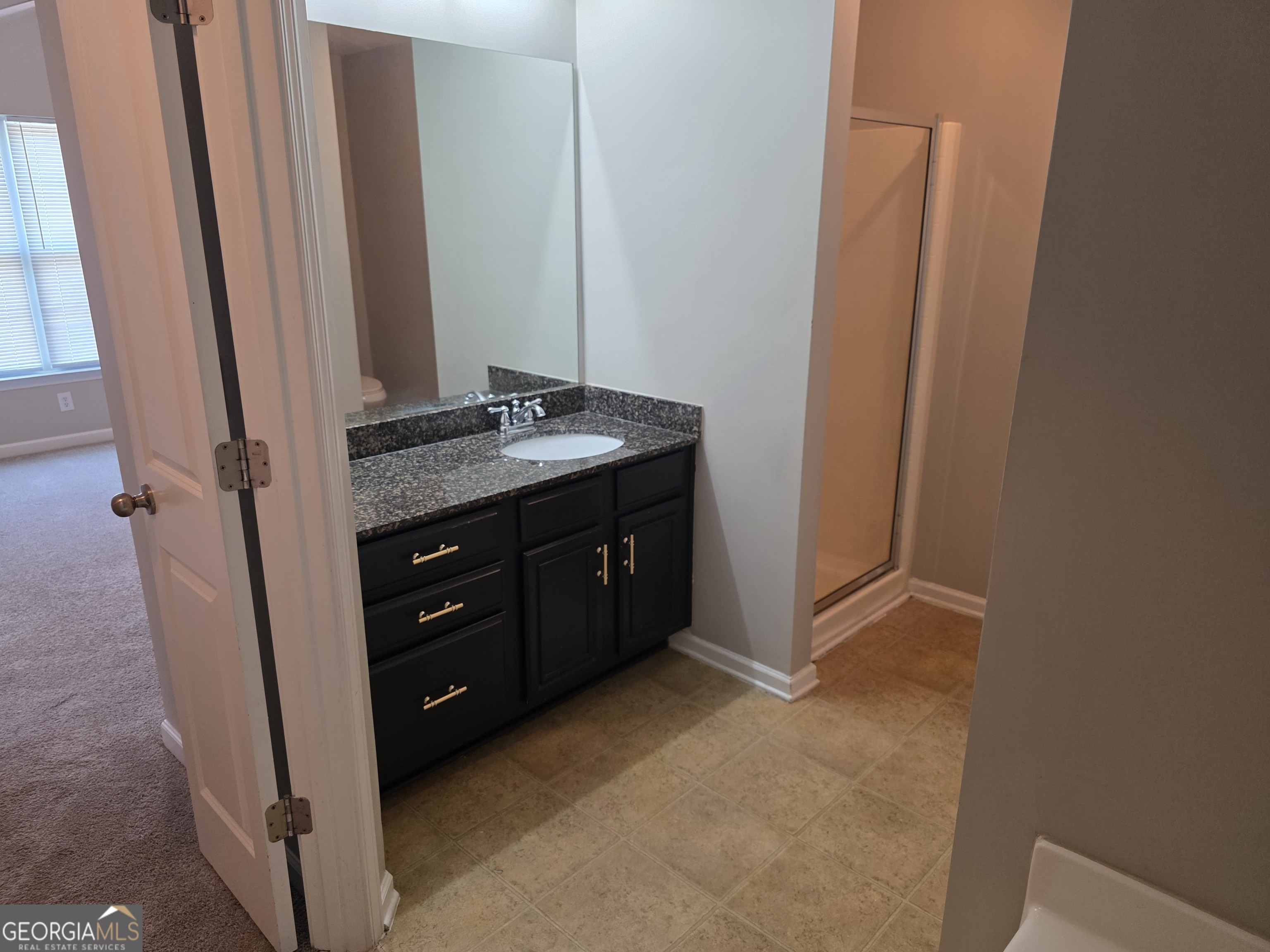 2873 Ridgeview Drive Atlanta, GA 30331 - Photo 25 of 32 a bathroom with a granite countertop sink and a mirror
