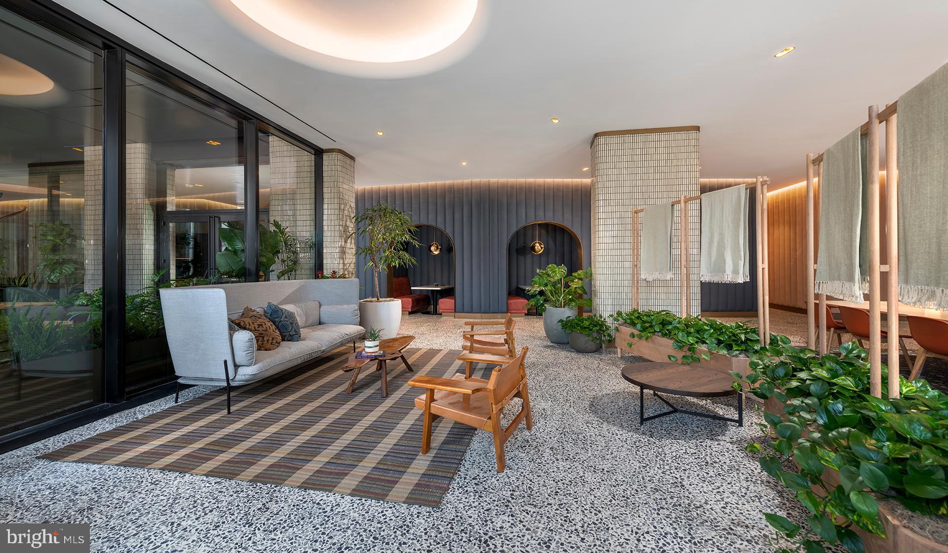 4710 Elm Street, Unit 1BE2003 Bethesda, MD 20814 - Photo 53 of 91 a living room with patio furniture and a potted plant