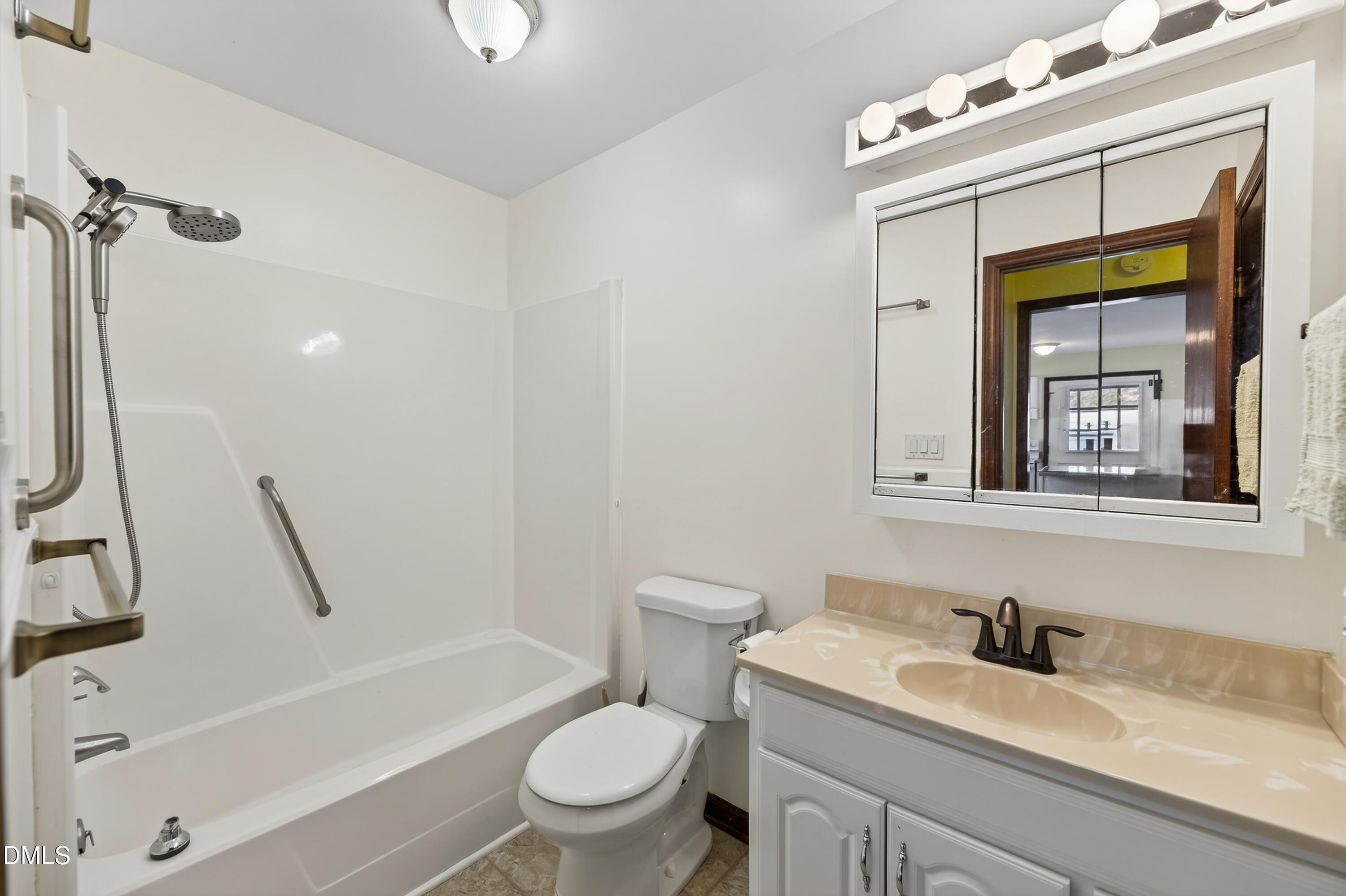 624 Wagstaff Road Fuquay-Varina, NC 27526 - Photo 14 of 39 a bathroom with a granite countertop sink toilet a mirror and bathtub