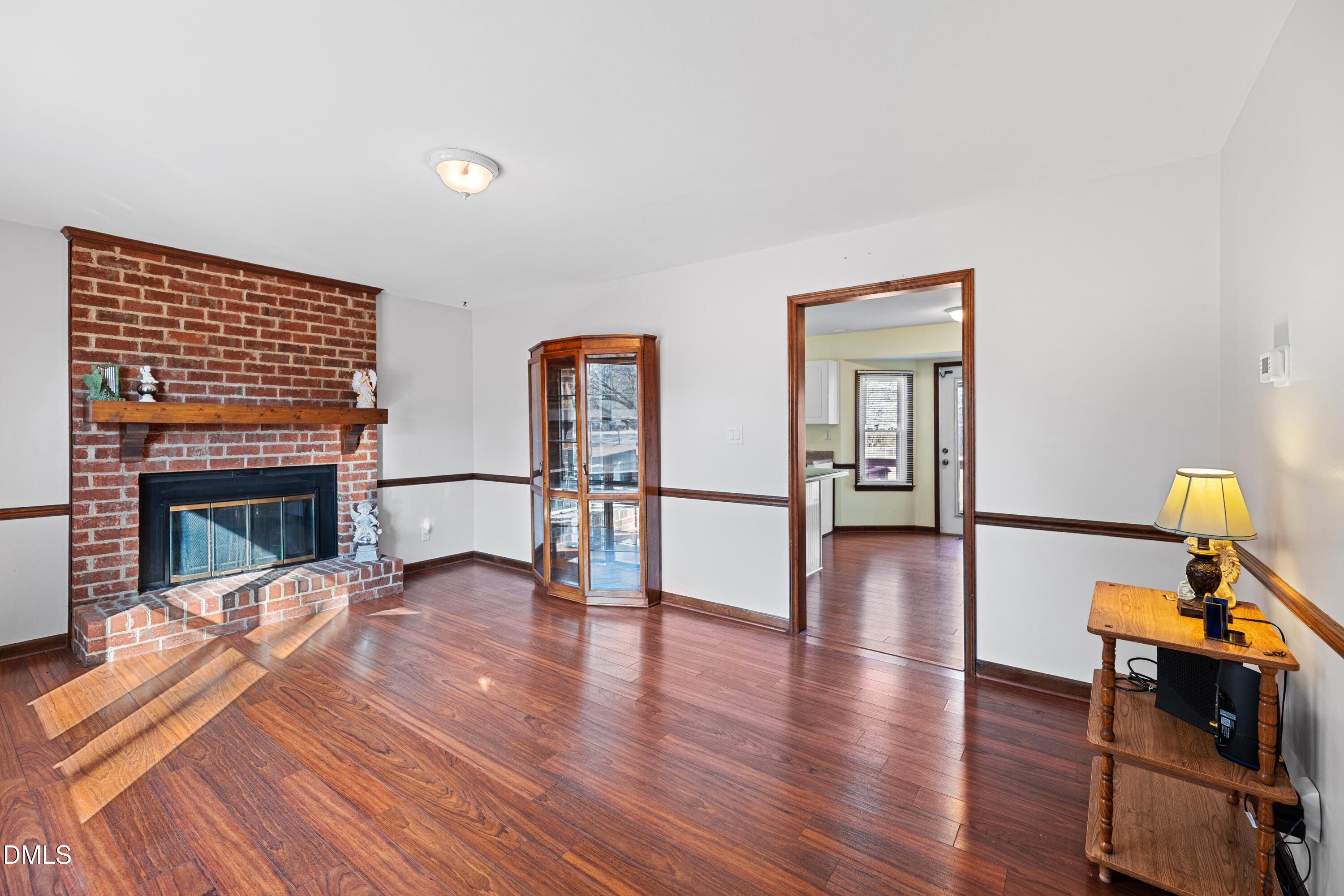 624 Wagstaff Road Fuquay-Varina, NC 27526 - Photo 3 of 39 a view of a livingroom with furniture a fireplace and wooden floor