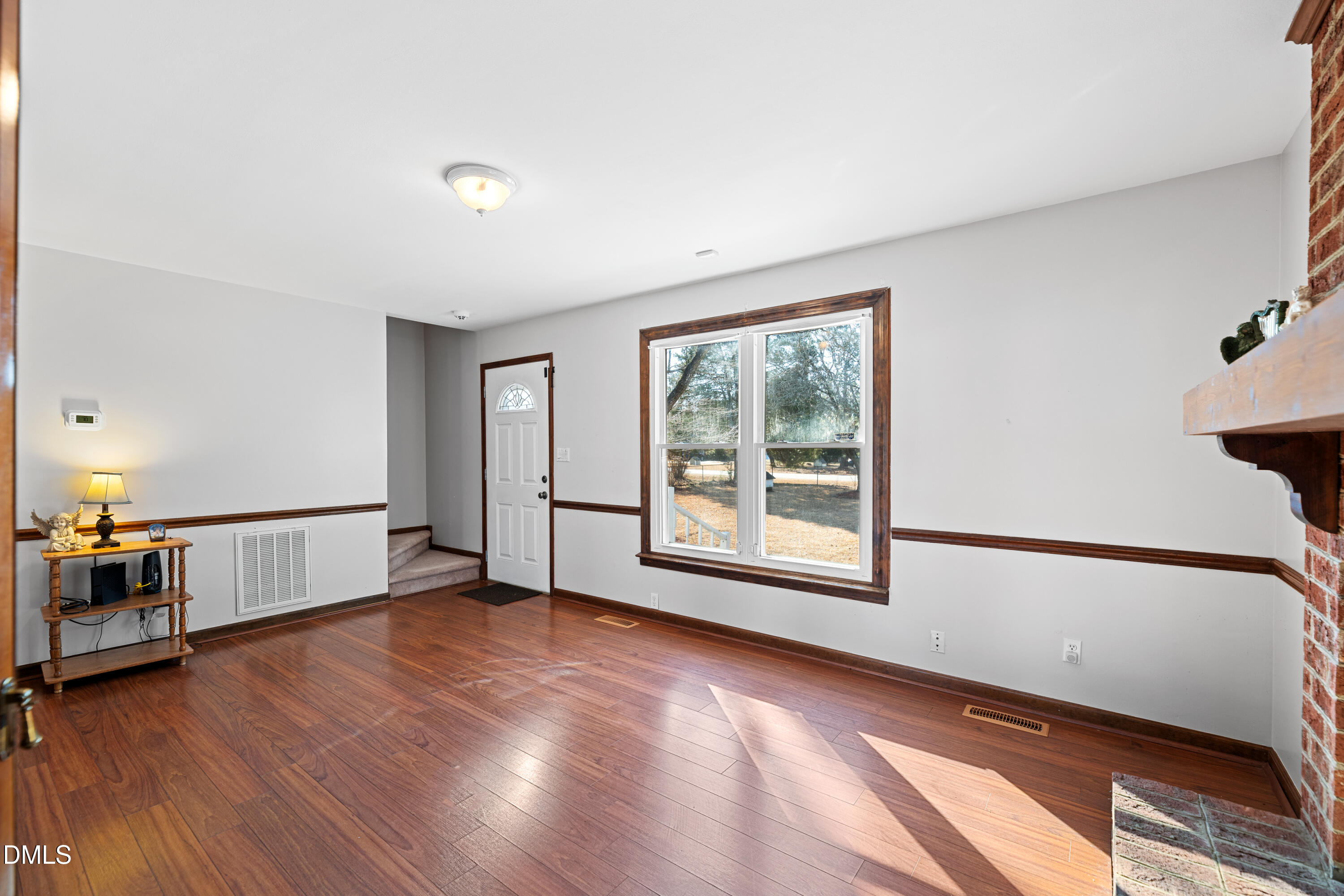624 Wagstaff Road Fuquay-Varina, NC 27526 - Photo 5 of 39 a view of an empty room with window wooden floor and windows