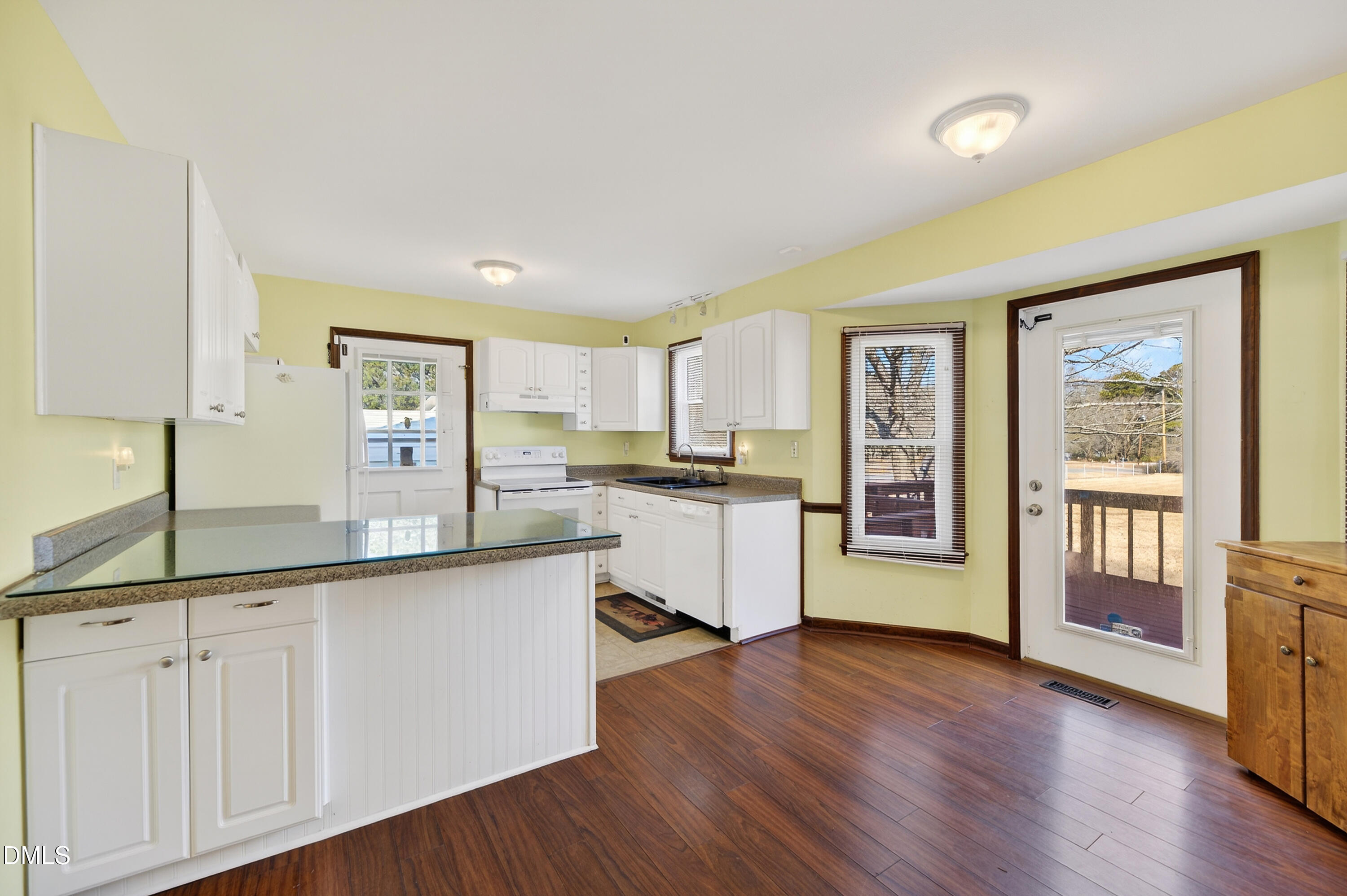 624 Wagstaff Road Fuquay-Varina, NC 27526 - Photo 7 of 39 a kitchen with white cabinets and wooden floor