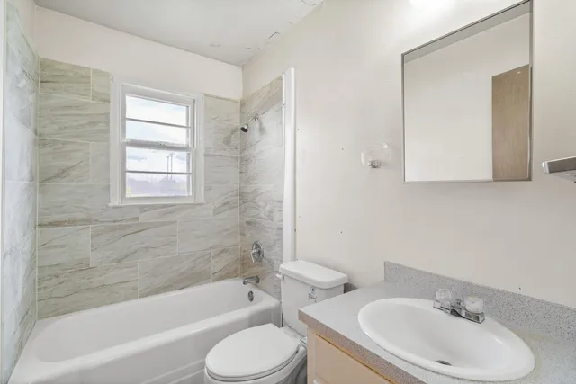 a bathroom with a sink toilet and bathtub