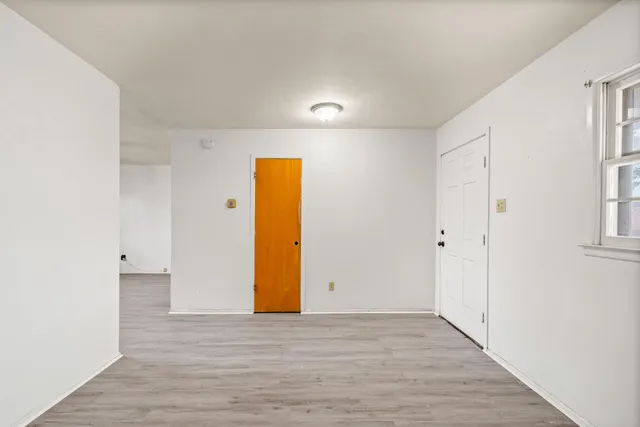 a view of a room with a wooden floor