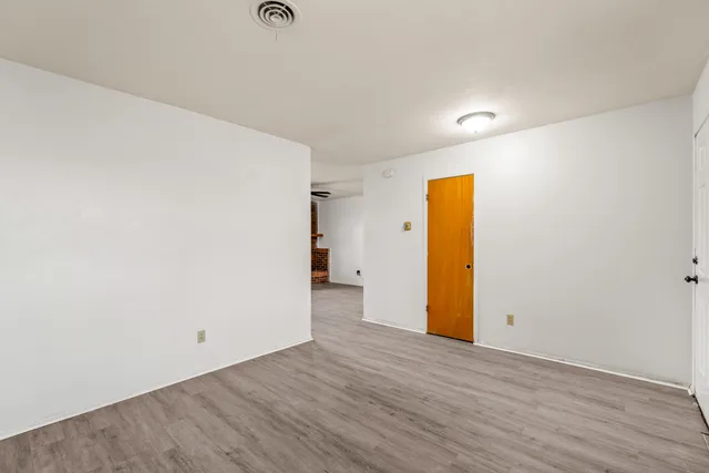 a view of a room with wooden floor
